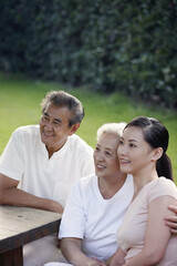 Obraz premium Woman with senior couple in the park