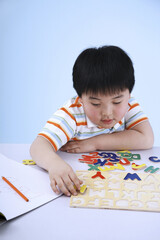 Boy playing with alphabet puzzle