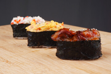 3 pieces of Japanese sushi on wooden platter