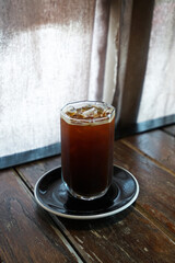 Close up iced black Americano coffee on wooden table