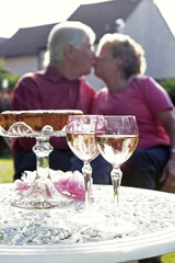 An old couple kissing in the garden