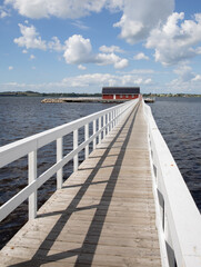 Fototapeta premium white bridge going out into the water 