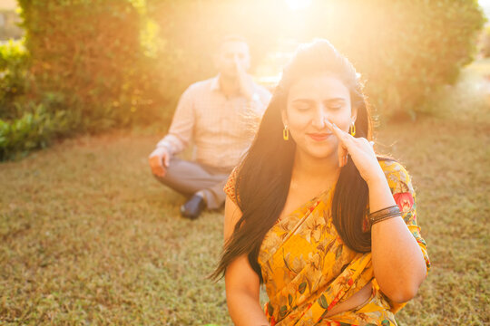 Two Indian People Doing Pranayama Breathing Techniques In The Park Outside