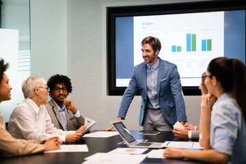 Image of business partners discussing documents and ideas