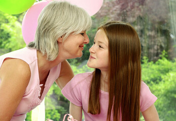 A woman giving her daughter a birthday kiss