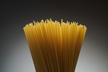Close up of raw unprepared spaghetti on black background