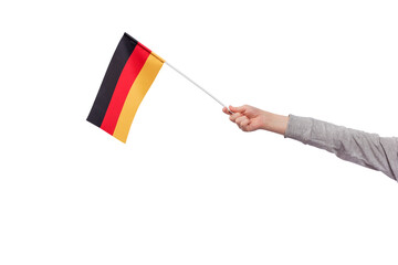 Childrens hand holds flag of Germany isolated on white background. Tricolor flag of black, red, yellow