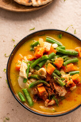 Indian or Thai Curry Soup Served in Bowl with Fresh Beans