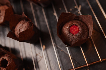 Cooking delicious homemade muffins with strawberry jam. Homemade baking.