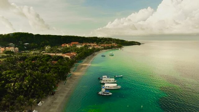 An early morning aerial view of a tranquil West Bay turquoise beach in Roatan, Honduras.
