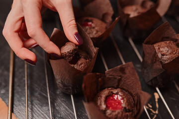 Cooking delicious homemade muffins with strawberry jam. Homemade baking.