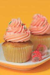 Pink cupcakes on a yellow background