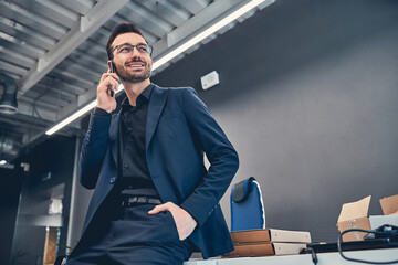Smiling business man making call by mobile