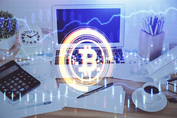 Double exposure of blockchain and crypto economy theme hologram and table with computer background. Concept of bitcoin cryptocurrency.