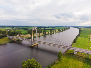 Obraz premium aerial view of the polder landscape with a river and a bridge