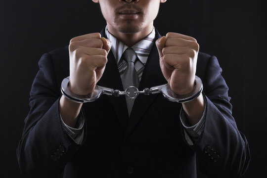 Businessman in handcuffs