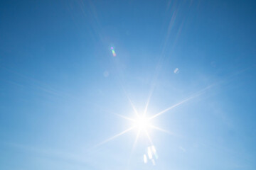 Fototapeta na wymiar Sunbeams in the blue sky. Natural phenomenon. The nearest star of our system, i.e. the sun.