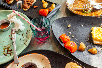 dirty dishes plates and glass on the table in cafe