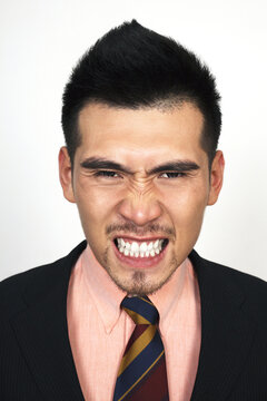 Angry businessman clenching teeth