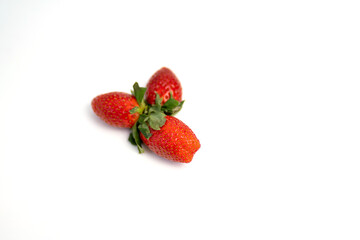 Red and fresh strawberries isolated on white