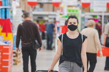 Obraz na płótnie Canvas woman in medicine mask do groceries shopping