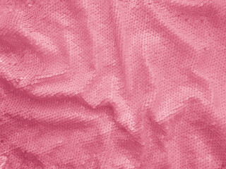Fototapeta na wymiar Background fabric sequin in pink color. Holiday abstract glitter background with blinking lights. Fashion fabric glitter. 