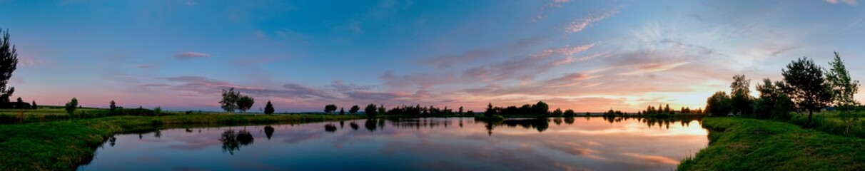 panorama of a beautiful sunrise on a summer lake