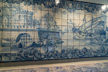 Fragment of old building wall with glazed ceramic white tiles, with blue painted scene. Traditional Portuguese architecture heritage. Chinese museum. 