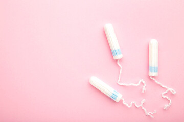 Menstrual tampons on a pink background. Cotton tampon for women