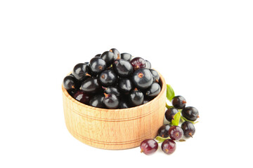 Black currant in wooden bowl isolated on white background.