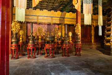 Temple interior, indoors, golden ornamets and typical Chinese letters