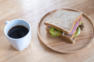 home made Wholewheat sandwich clean food with coffee on wood table natural light