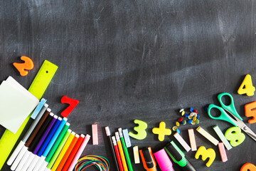 School supplies on the background of the blackboard ready for your design. Copy space for text. Back to school.