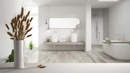 White table top or shelf with straws, dry plants, ornament, ears, sheaf, branch in vase, over white bathroom with bathtub, parquet and decors, modern minimal interior design