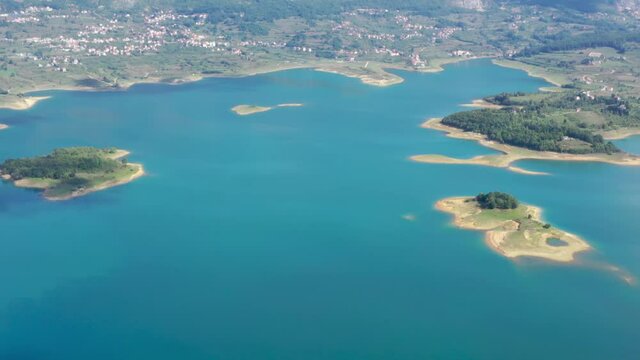 Town of Ripci on the northern shore of Rama Lake in Bosnia and Herzegovina, Aerial dolly out high shot