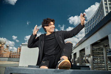 Cheerful young man making selfie on the street