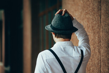 Man in vintage suit and hat from the back