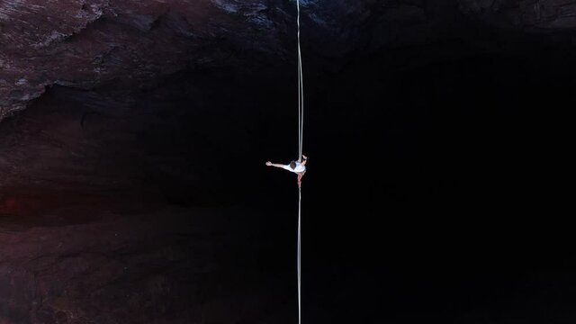Extreme sport of slacklining, top view on a man walking the tightrope, 4k