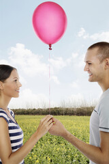 Man and woman holding a balloon