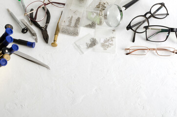 Top view of optical workplace.Conept of glasses fixing.Professional tools for eyeglasses...