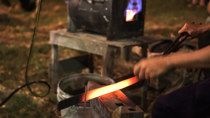 Blacksmith making hitting sword handmade traditional craftmanship show