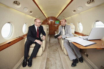 Businessmen working in private jet