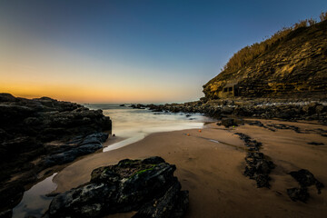 Fototapeta na wymiar Sunset in a rocky beach