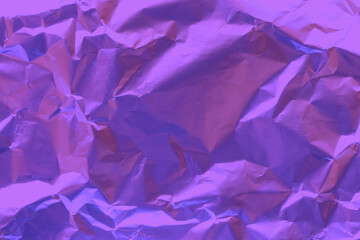Crumpled purple foil. Purple foil background. Foil texture
