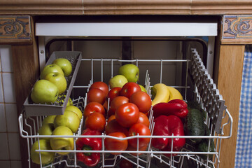 Set of fruits and vegetables in the kitchen dishwasher.