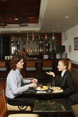 Businessman and businesswoman having a meal in a restaurant