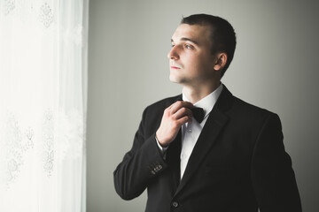 Young handsome man relaxing at his apartment in a hotel after business meeting