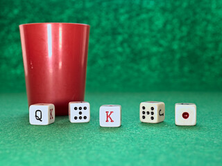 Poker dice game on a green tablecloth