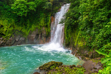 Waterfall and natural pool with turquoise, blue water of Rio Celeste in Tenorio Volcano national park, Costa Rica. Central America.