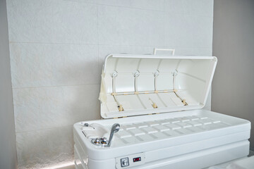 Open spa capsule in modern beauty salon placed by the wall